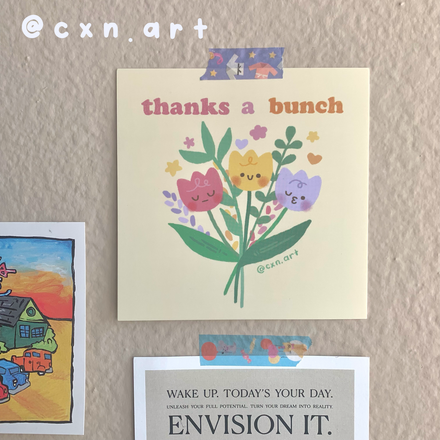 Floral card with 'thanks a bunch' text on a textured surface with other cards.
