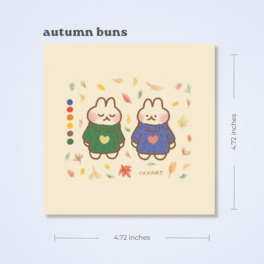 Illustration of two cute bunnies dressed in comfy cozy sweaters with autumn leaves on a beige background, labeled 'autumn buns'. illustration cxnart