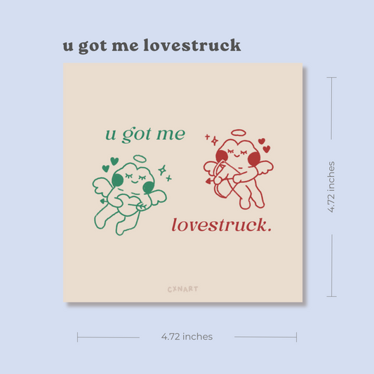 Card with illustrations of two frog cupids and text 'u got me lovestruck' on a beige background. green frog on the left and red frog no the right