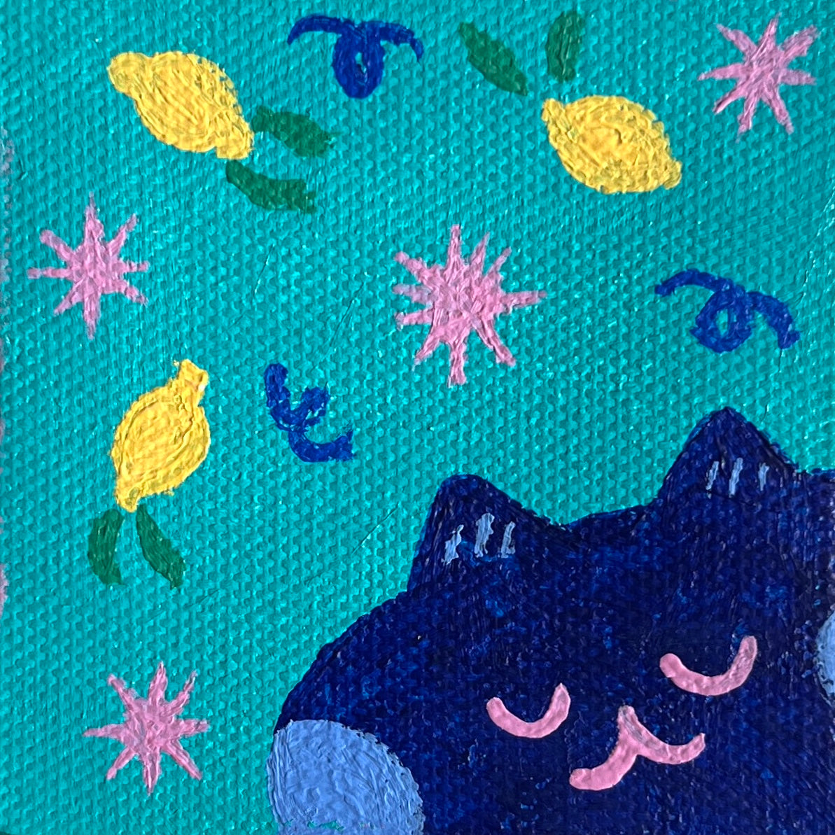 Painting of a cat, lemons, and stars on a blue background